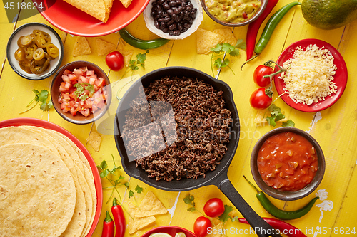 Image of Various fresh and tasty ingredients for chilli con carne. With meat on iron pan