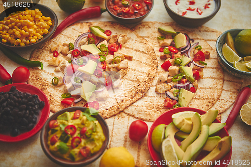 Image of Freshly made healthy corn tortillas with grilled chicken fillet, big avocado slices