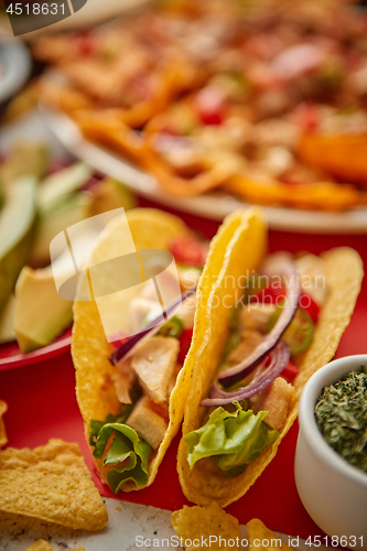 Image of Close up on crispy tacos with various freshly made Mexican foods assortment