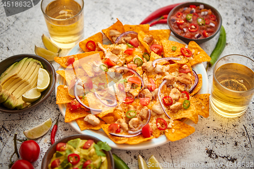 Image of Mexican corn nacho spicy chips served with melted cheese