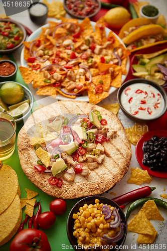 Image of Various freshly made Mexican foods assortment. Placed on colorful table