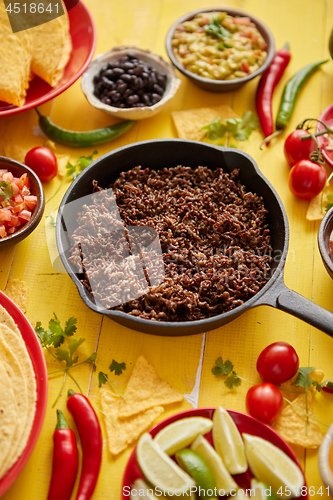 Image of Various fresh and tasty ingredients for chilli con carne. With meat on iron pan