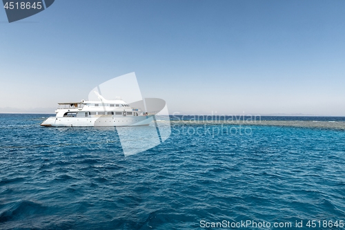 Image of Luxury yacht docking near coral reef