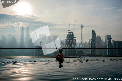 Image of Relaxing in pool and enjoying city panorama. Kuala Lumpur, Malaysia