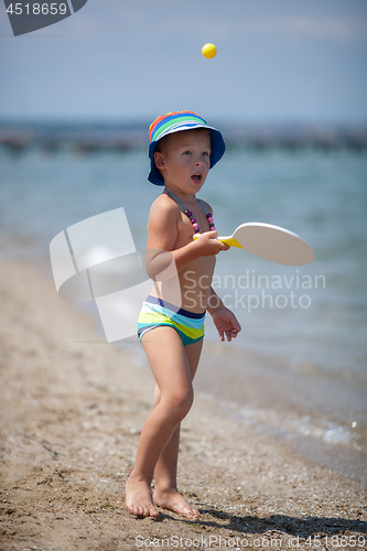 Image of Playful boy on the beach. Fun on summer vacation