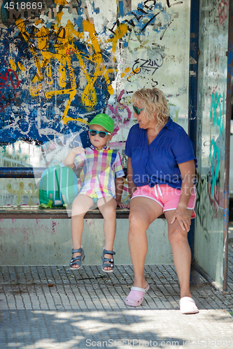 Image of Multicolor beach people at a bus stop