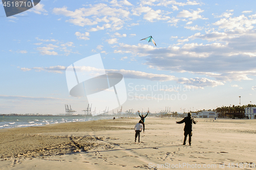 Image of Flying a kite on the beach