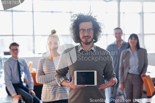 Image of Portrait of a young businessman holding tablet