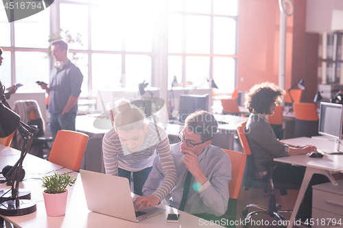 Image of Two Business People Working With laptop in office