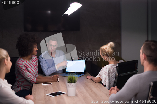 Image of Multiethnic startup business team in night office