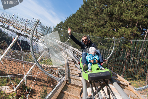 Image of father and son enjoys driving on alpine coaster