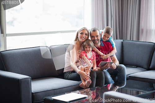 Image of happy young couple spending time with kids