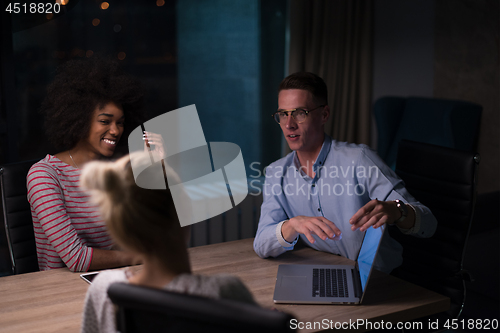 Image of Multiethnic startup business team in night office