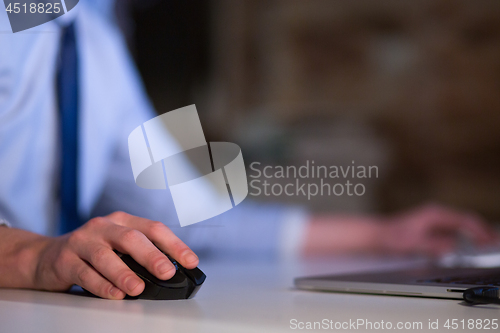 Image of Hand using computer mouse closeup