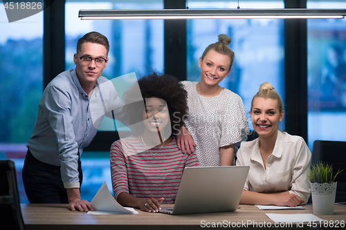 Image of Multiethnic startup business team in night office