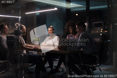 Image of Multiethnic startup business team in night office