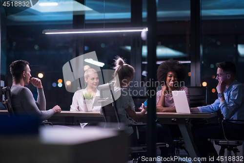 Image of Multiethnic startup business team in night office