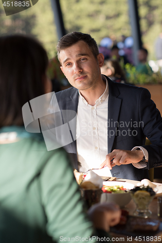 Image of Closeup shot of young woman and man having meal.