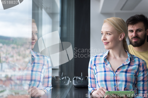 Image of Pretty Businesswoman Using Tablet In Office Building by window