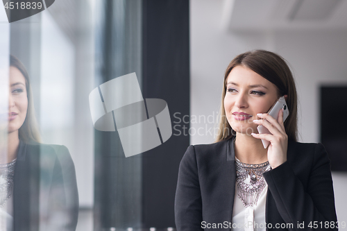 Image of Business Girl Standing In A Modern Building Near The Window With