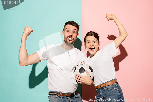 Image of The young fans celebrating on blue and pink trendy colors.