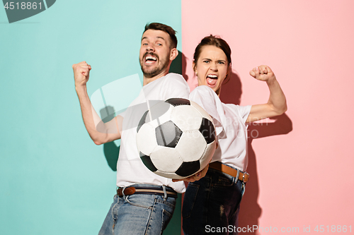 Image of The young fans celebrating on blue and pink trendy colors.