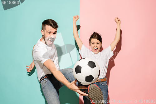 Image of The young fans celebrating on blue and pink trendy colors.