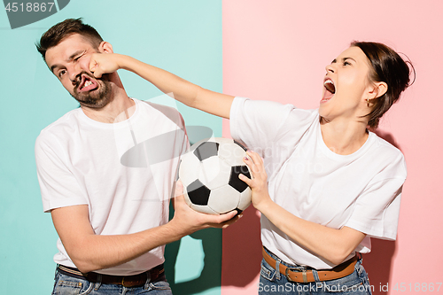 Image of The unhappy and angry fans on colored blue and pink background.