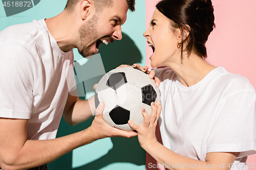 Image of The unhappy and angry fans on colored blue and pink background.