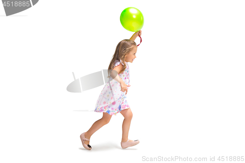 Image of Smiling cute toddler girl three years running over white background