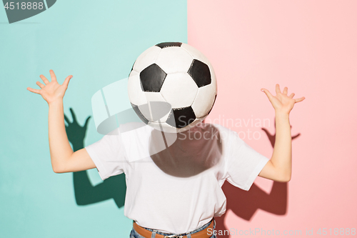 Image of The young fan with ball instead of head on blue and pink trendy colors.