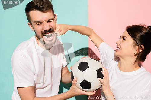 Image of The unhappy and angry fans on colored blue and pink background.