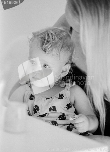 Image of Black and white portrait of baby girl with mum at home