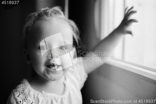 Image of Portrait of happy one year old girl in black and white