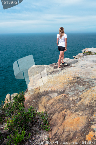 Image of Woman gazing out from the cliff top views Royal National Park