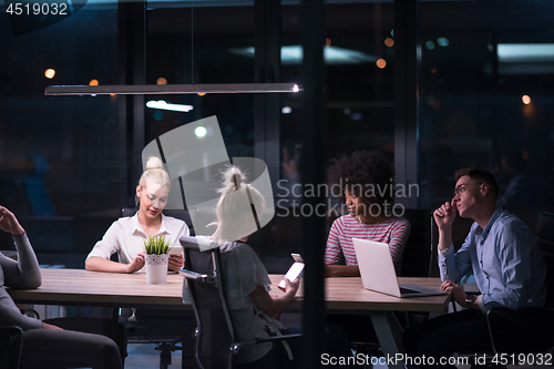 Image of Multiethnic startup business team in night office