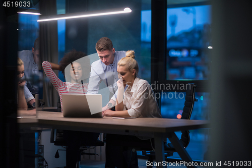 Image of Multiethnic startup business team in night office