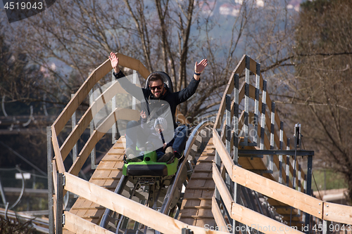 Image of father and son enjoys driving on alpine coaster