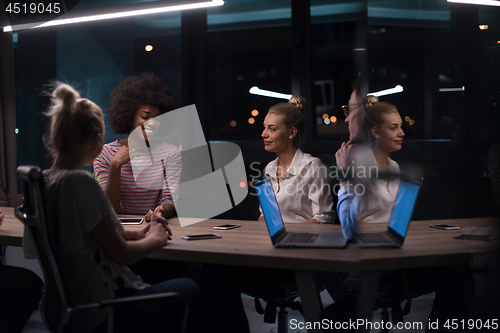 Image of Multiethnic startup business team in night office