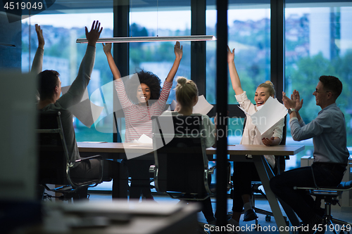 Image of multiethnic Group of young business people throwing documents