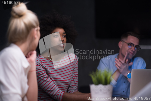 Image of Multiethnic startup business team in night office