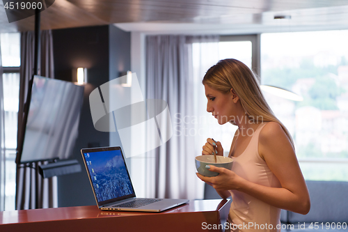 Image of woman eating breakfast enjoying relaxing lifestyle