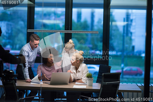 Image of Multiethnic startup business team in night office