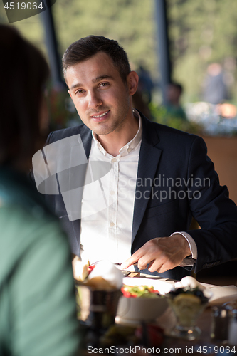 Image of Closeup shot of young woman and man having meal.