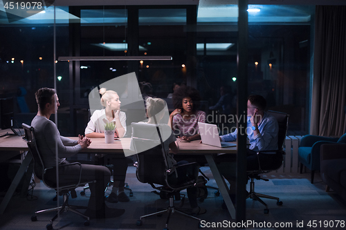 Image of Multiethnic startup business team in night office