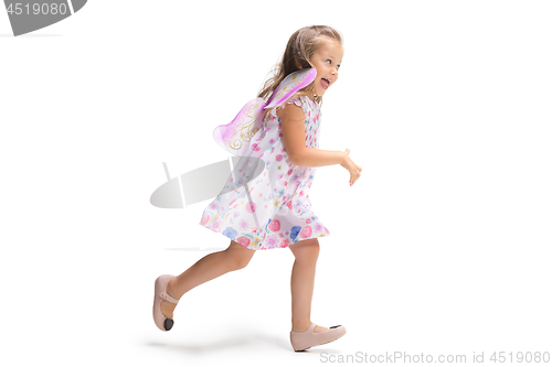 Image of Smiling cute toddler girl three years running over white background