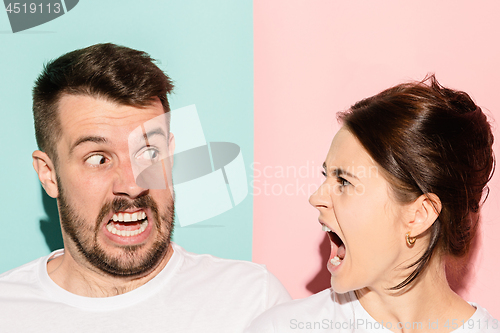 Image of attractive angry couple fighting and shouting at each other