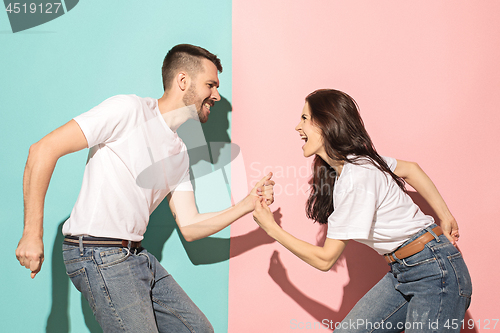 Image of A couple of young man and woman dancing hip-hop at studio.