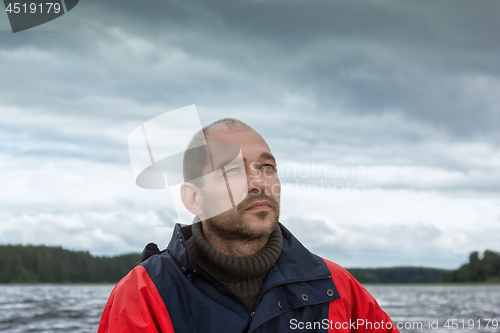 Image of Conceptual Portrait Of A Bearded Man Against A Overcast Sky