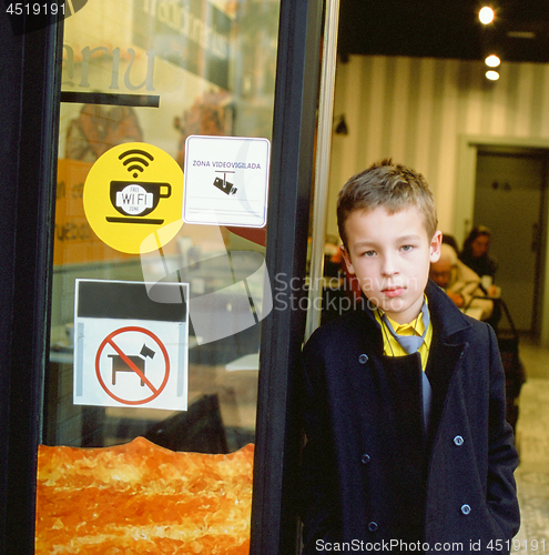 Image of Schoolchild at the cafe doorway